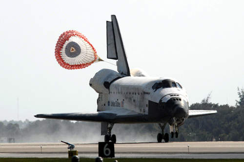 After touchdown, the speed-brake on the vertical tail and a drogue parachute are deployed to bring Discovery to a halt in November 2007.