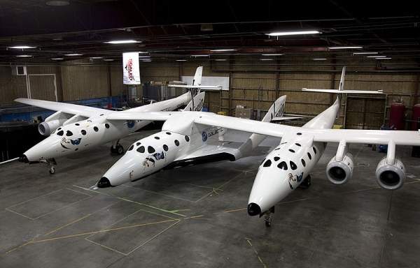 SpaceShipTwo attached to its mothership, White Knight Two, inside a hangar in Mojave, Caalifornia, US. Image courtesy of Virgin Galactic.