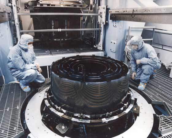 Workers at Eastman Kodak in Rochester, N.Y., check the alignment of the Chandra observatory's High-Resolution Mirror Assembly.